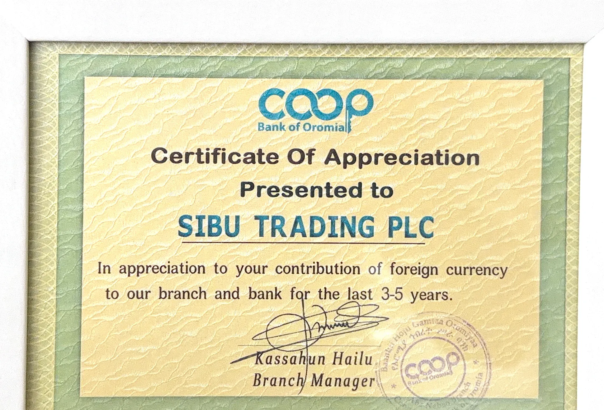 Cooperative Bank of Oromia Certificate of Appreciation presented to Sibu Trading PLC